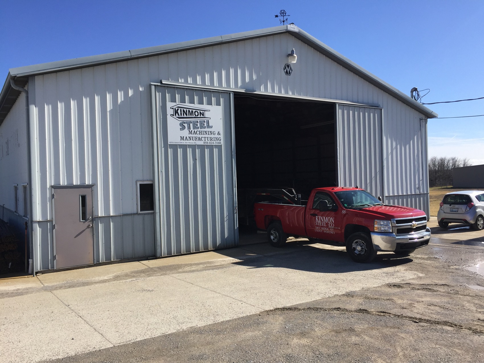 The Kinmon Steel building in Dry Ridge, Kentucky, with the company truck at the open bay door