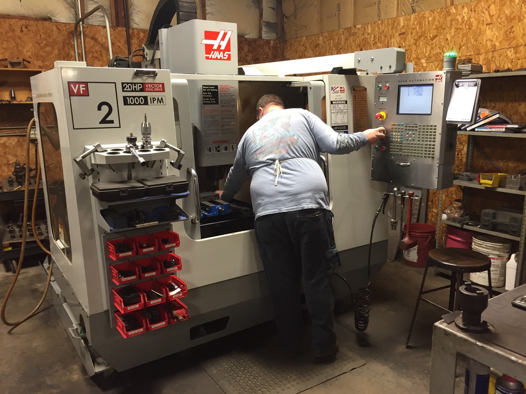 A machinist running the Haas vertical machining center on the Kinmon Steel shop floor